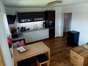 a kitchen and living room with a table and a counter at Ferienwohnung Schneckenpointner in Waging am See +5 photos
