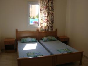 Postel nebo postele na pokoji v ubytování Marios Apartments