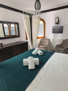 a bedroom with a large bed with towels on it at Casa Vida Feliz in El Verger