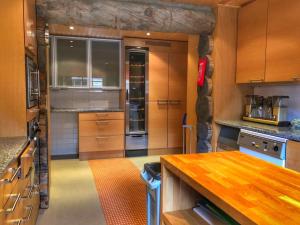 a kitchen with wooden cabinets and a wooden counter top at Santa's Villa Borealis in Luosto