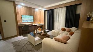 a living room with a couch and a table at Rest by Dedeman Elbistan in Elbistan