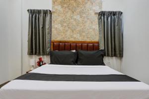 Postel nebo postele na pokoji v ubytování Hotel O KP Pride