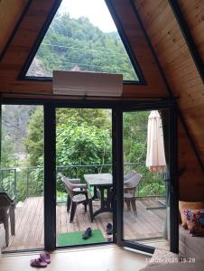 a view from the inside of a cabin with a large window at La Vica Bungalow in Rize