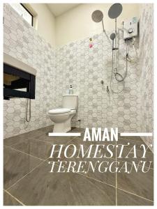 a bathroom with a shower and a toilet in a room at Aman Homestay, Marang in Marang +11 photos