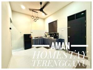 a kitchen with a black door in a room at Aman Homestay, Marang in Marang