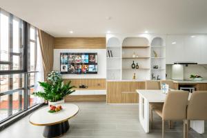 a kitchen and living room with a table and a dining room at Myrcella Urban Apartment in Hanoi +37 photos