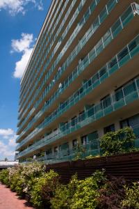 a tall building with a lot of windows at AdrianApartments ViVa in Cluj-Napoca