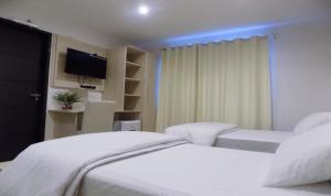Un ou plusieurs lits dans un hébergement de l'établissement Danieri Asunción Hotel