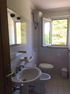 a bathroom with a sink and a toilet at La Colombella in Montemonaco