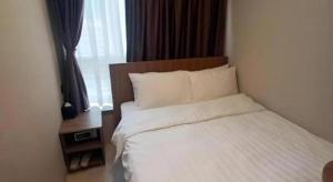 Uma cama ou camas num quarto em WE Hotel Kowloon