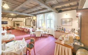 a dining room with tables and chairs and tablesktop at Hotel Embassy in Karlovy Vary