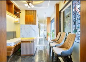 a room with a row of chairs and a bed at The Royal Nest Inn in Panchanai