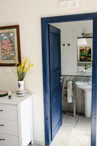 a bathroom with a blue door and a sink at Casa Cerqua Landi in Itri