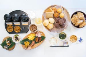 a table with plates of food and bowls of food at Hotel Santa Barbara Miyakojima Resort in Miyako-jima