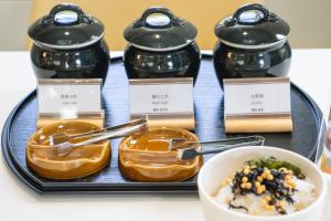 a tray of food on a table with a plate of food at Hotel Santa Barbara Miyakojima Resort in Miyako-jima