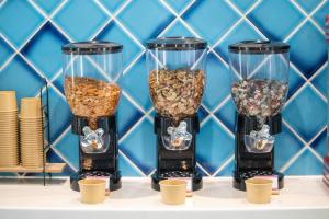 four tall glass vases filled with different types of seeds at Hotel Santa Barbara Miyakojima Resort in Miyako-jima