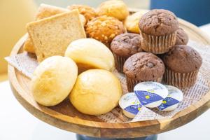 a plate of different types of bread and muffins at Hotel Santa Barbara Miyakojima Resort in Miyako-jima
