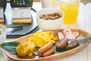 a plate of food with different types of food on a table at Hotel Santa Barbara Miyakojima Resort in Miyako-jima