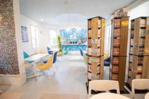 a room with chairs and tables and bookshelves at Hotel Santa Barbara Miyakojima Resort in Miyako-jima