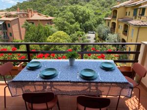 a blue table on a balcony with a view at La Pareina in Porto Ercole