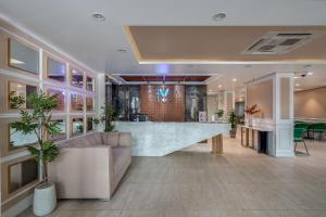 a lobby with a bar in the middle of it at SAZI RESIN HOTEL - Free Nails HairWash in Ho Chi Minh City