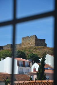 a view of a castle from a window at Hostel Rossio Alcobaça in Alcobaça
