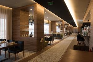 a restaurant with tables and chairs and a bar at Octant Ponta Delgada in Ponta Delgada
