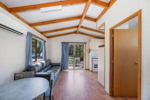 a living room with a couch and a table at Reflections Tumut River in Tumut