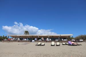 - un groupe de personnes assises sur la plage dans l'établissement Wood House Close Beach, à Marbella