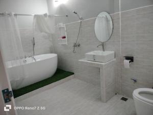 a bathroom with a tub and a sink and a mirror at Evie Mae Camp in Ban Cha-om +36 photos