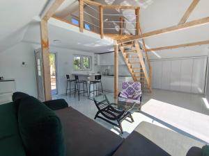 a living room with a loft bed and a table at Apartman TERASA in Beljevina