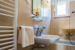 a bathroom with a sink and a mirror at Apartment Dominik in Podstrana +19 photos