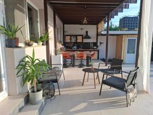 a patio with chairs and a table on a building at Elysium Retreat in Cinciş