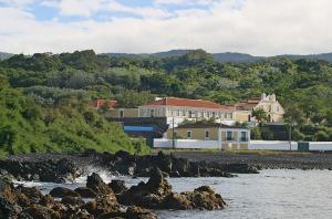 a group of houses on a hill next to a river at Quinta das Merces in Angra do Heroísmo