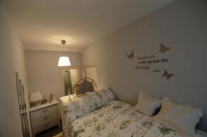 a bedroom with a bed with butterflies on the wall at La Maison Sabina in Passo Corese