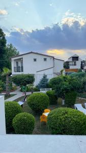 a park with benches and trees and a building at Complex Minerva in Costinesti
