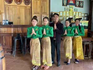 a man and a group of children giving the thumbs up at Ratanakiri Phum Khmer resort in Banlung +53 photos