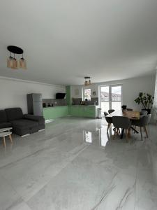 un ampio soggiorno bianco con un tavolo e un divano di Apartament Ilinca - 2 dormitoare a Bistriţa Altre 19 foto