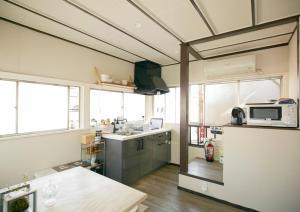 a kitchen with a sink and a microwave at 328 Hostel & Lounge in Tokyo