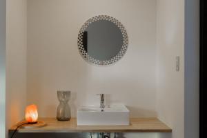 a bathroom with a sink and a mirror on the wall at Forest and Stars Akakura Sauna in Myoko +26 photos