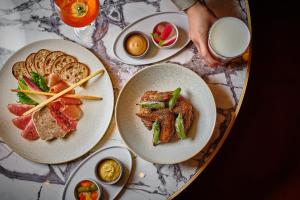 a table with three plates of food on it at Hyatt Regency Tokyo in Tokyo