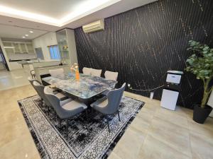 a dining room with a table and chairs at Bungalow Perkasa Kuala Lumpur in Kuala Lumpur