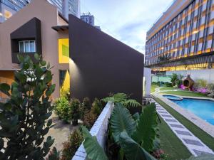 a building with a swimming pool next to a building at Bungalow Perkasa Kuala Lumpur in Kuala Lumpur