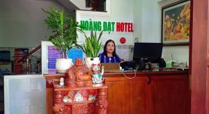 a woman sitting at a desk in an office at Hoàng Đạt Hotel Q9 - by BAY LUXURY in Long Thạnh Mỹ