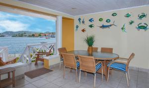 a dining room with a table and chairs at The Harbour #6 - 3 Bedrooms in Rodney Bay townhouse in Gros Islet