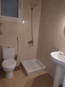 a bathroom with a toilet and a sink at Mousa Cost Resort عائلات فقط in Ras Sedr +10 photos