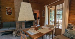 a living room with a table and a fireplace at kuscheliges Waldhaus Kaminknistern in Oldendorf
