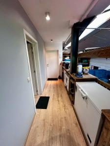 a kitchen with a counter top and a wooden floor at Ter Loft Courgette in Ternat +14 photos