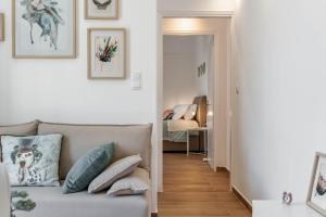 a living room with a couch and a bedroom at ΙΖΑΜΠΩ II in Kalamata