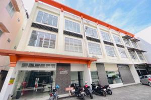 a group of motorcycles parked in front of a building at RedDoorz at STM Suite Medan Amplas in Medan